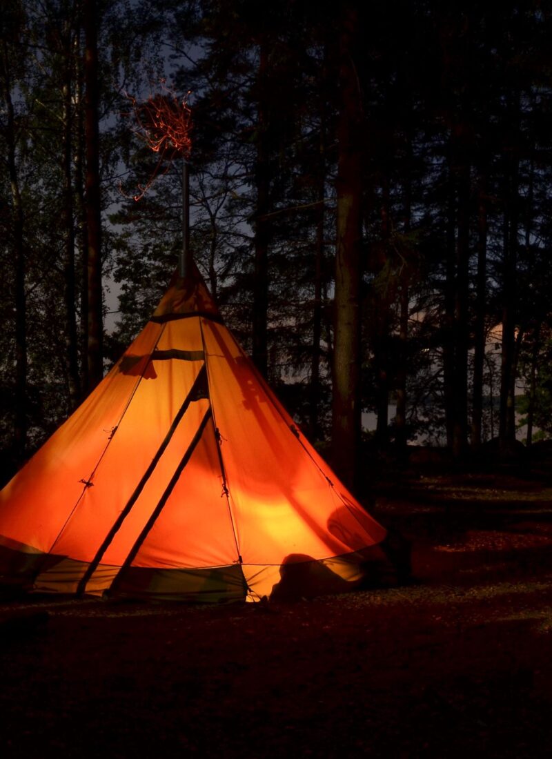 Kvällsbild på upplyst tält vid Törestorps camping, Glasriket