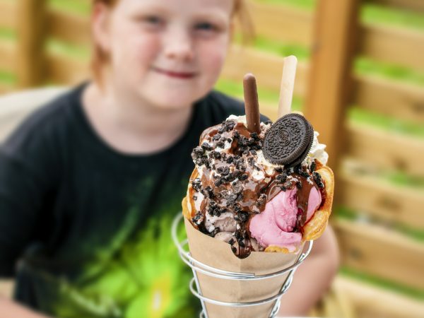 Large scoop of ice cream with children in the background, the Ice Cream Bar in Kosta, Glasriket