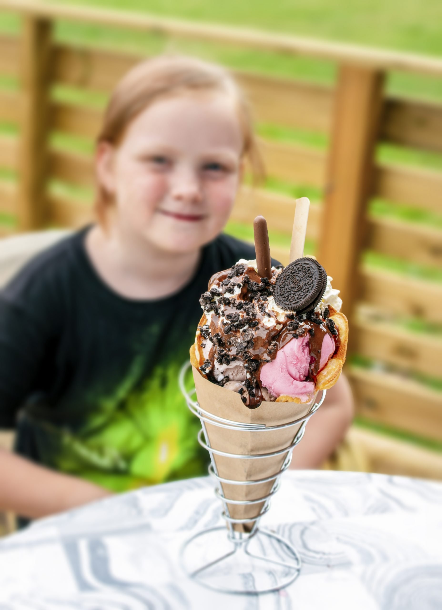 Large scoop of ice cream with children in the background, the Ice Cream Bar in Kosta, Glasriket