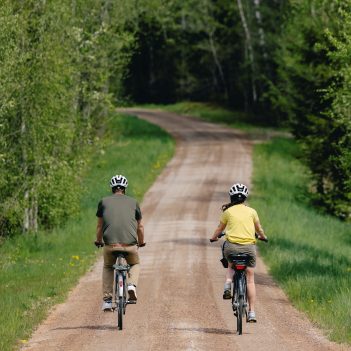 Cyclists on an excursion on a dirt road in the Kingdom of Glass